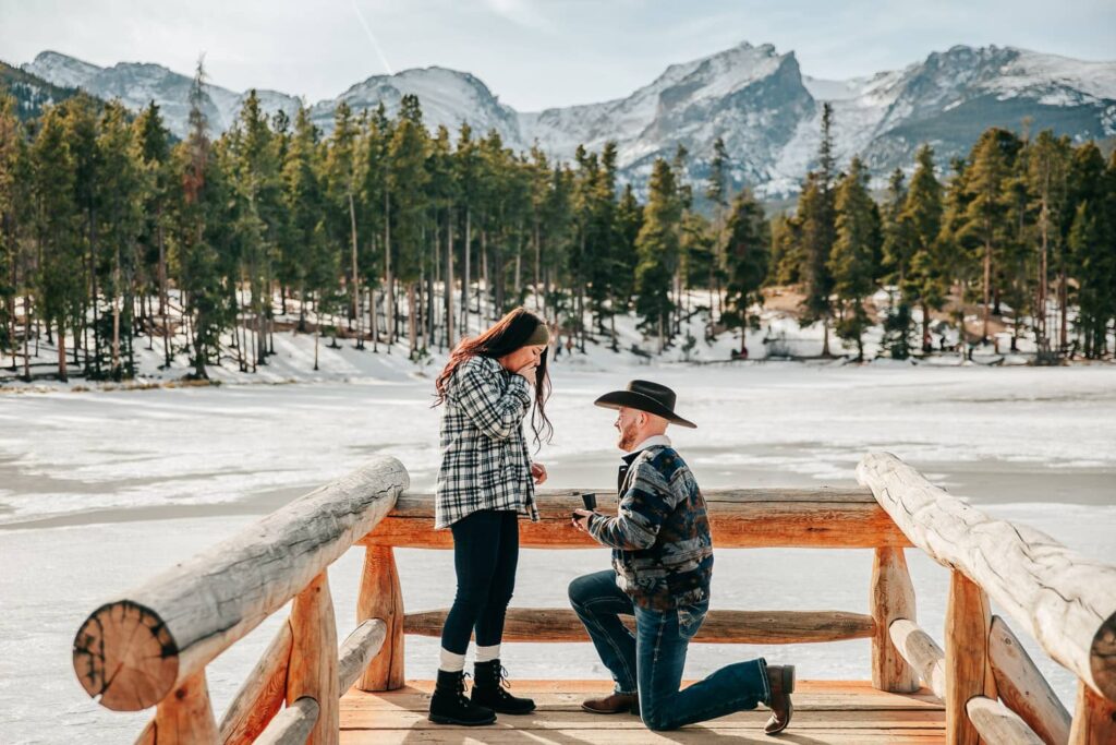 A man proposing to his girlfriend in Rocky Mountain National Park.