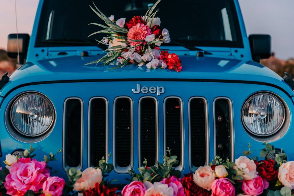 Blue jeep with bridal bouquet and jeep florals, decorated for a moab elopement.