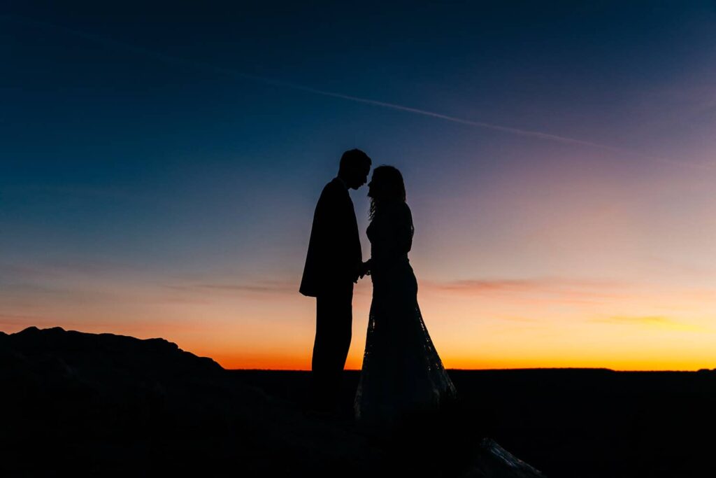 A silhouette of couple during their elopement.