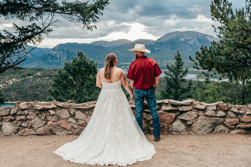 Couple looking at the mountains after their sapphire point elopement
