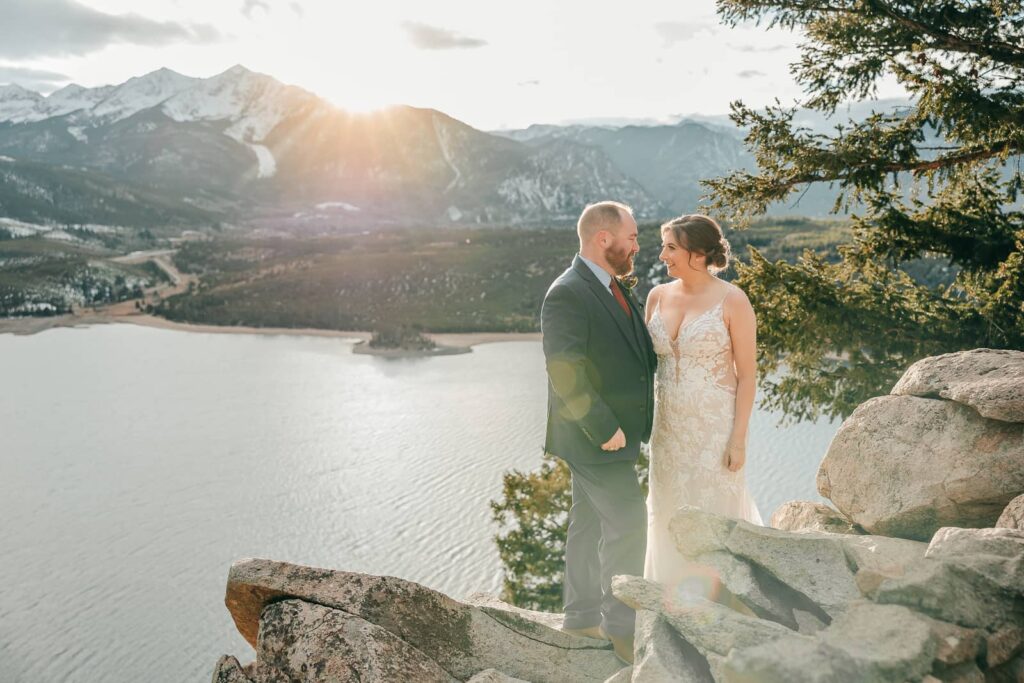 Couple in wedding attire standing on a rock at sapphire point overlook